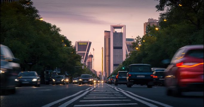 Timelapse of sunset in madrid. Close up traffic as foreground and Madrid downtown as background.