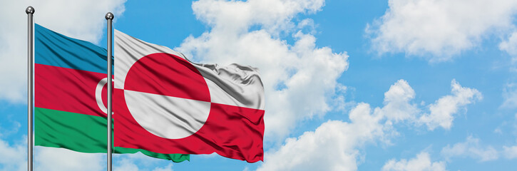 Fototapeta na wymiar Azerbaijan and Greenland flag waving in the wind against white cloudy blue sky together. Diplomacy concept, international relations.