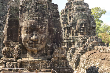 Faces carved in stone in Bayon temple towers, Angkor Wat complex, Cambodia, Siem Reap