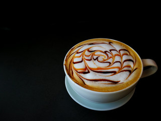 Coffee cup of  latte art  with chocolate sauce and caramel sauce  on Milk foam on desk wooden pattern
