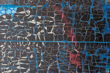 Abstract grunge background. Texture of torn old torn paper on the wall. Blue, red, black color.
