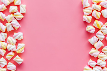 Sweets. Marshmallows frame on pink background top view copy space