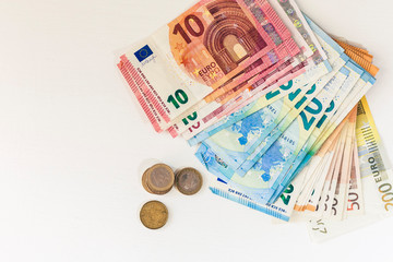 Close up money euro banknotes and coins on white background.