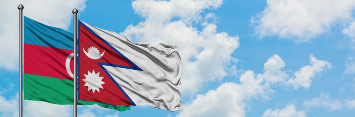 Azerbaijan and Nepal flag waving in the wind against white cloudy blue sky together. Diplomacy concept, international relations.