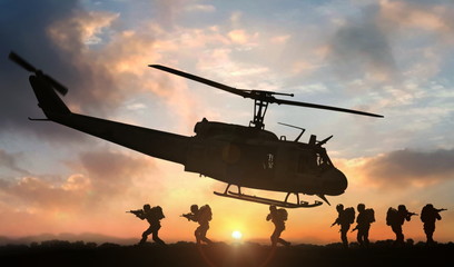 Military special force assault team helicopter drops during sunset - obrazy, fototapety, plakaty