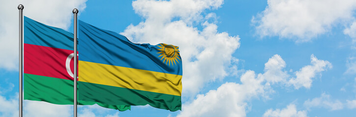 Azerbaijan and Rwanda flag waving in the wind against white cloudy blue sky together. Diplomacy concept, international relations.
