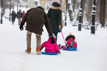 kids sliding at winter hill at city park