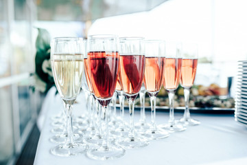 Glasses of white and pink wine on the table