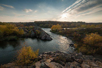 Fall landscape with river on sunset
