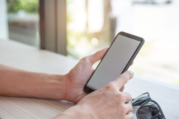 Businessman hand working with mobile phon on workplace in office.concept