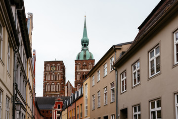 Traditional colorful houses and church tower in the old town of Stralsund