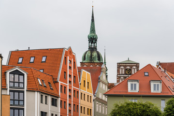 Traditional colorful houses and church tower in the old town of Stralsund