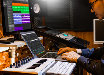 male producer, musician, composer making a song in home recording studio. music production concept