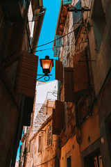 Fototapeta na wymiar A view of a narrow street in the Old Town of Rovinj, Croatia