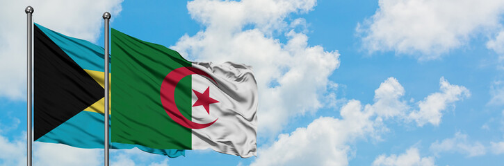 Bahamas and Algeria flag waving in the wind against white cloudy blue sky together. Diplomacy...
