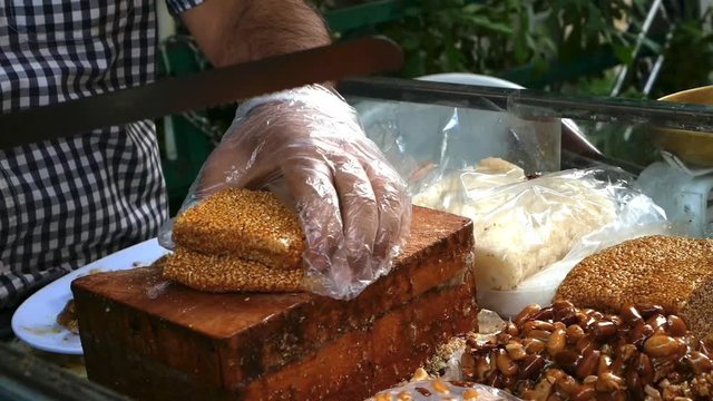 Typical Lebanese sesame sweets being cut at a snack sales stand in the city of Zahle, Lebanon
