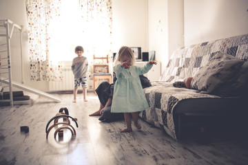 happy mom with two children on the floor in room