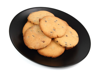 Chocolate chip cookies on black plate isolated on white background