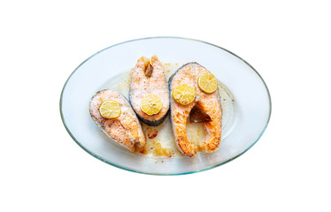 Baked in salmon in a glass baking dish isolated white background