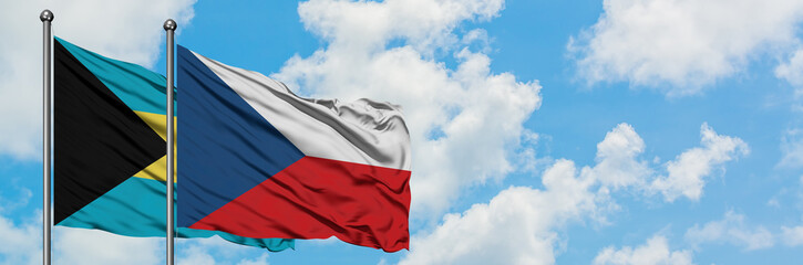 Fototapeta na wymiar Bahamas and Czech Republic flag waving in the wind against white cloudy blue sky together. Diplomacy concept, international relations.