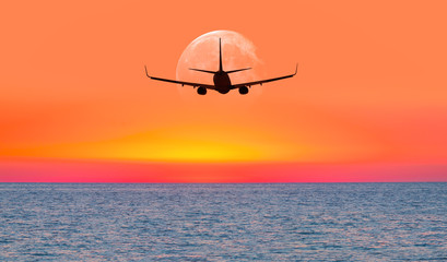 Fototapeta na wymiar Passenger airplane in the sky against full moon 