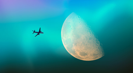 Passenger airplane in the sky against blue full moon and aurora borealis 