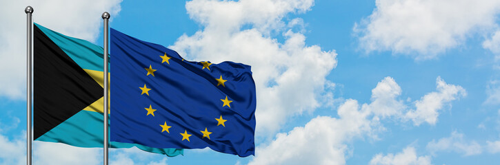 Bahamas and European Union flag waving in the wind against white cloudy blue sky together. Diplomacy concept, international relations.