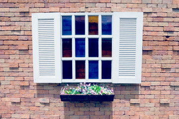 White wooden window and Flower pot on brick wall background,filter effect