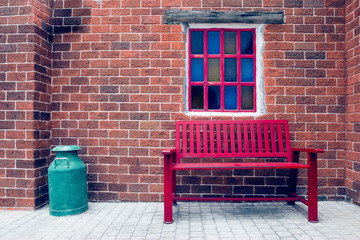 Red bench and windows on brick wall,filter effect