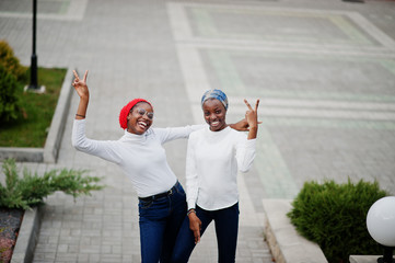Two young modern fashionable, attractive, tall and slim african muslim womans in hijab or turban...