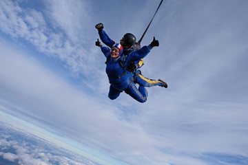 Fototapeta na wymiar Skydiving. Tandem jump. Two skydivers are in the sky.