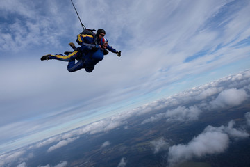 Fototapeta na wymiar Skydiving. Tandem jump. Two skydivers are in the sky.