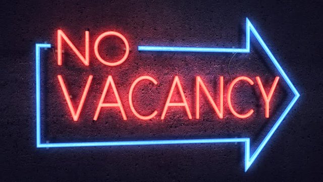 Realistic 3D render of a vivid and vibrant animated neon sign, with the words No Vacancy illuminated, with a concrete wall background