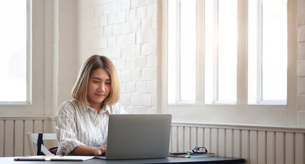 Business women working in office room enjoying sunny morning on the day with documents and laptop people Consulting and business planning. 