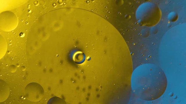 Abstract colorful background. Foam of Soap with Bubbles macro shot. Closeup bubbles in water. Oil drops on a water surface abstract background. Golden yellow bubble.Yellow water bubbles wallpaper. 4k 