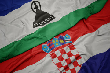 waving colorful flag of croatia and national flag of lesotho.