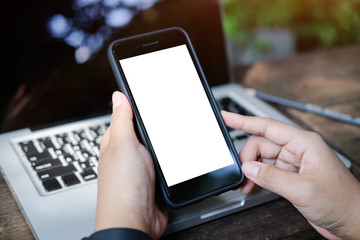 Cropped shot view Mock up smartphone of hand holding black mobile phone with blank white screen.
