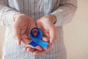 Man Hands holding blue ribbon, Prostate Cancer Awareness, November blue, Movember Men health...