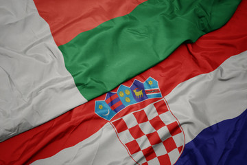waving colorful flag of croatia and national flag of madagascar.