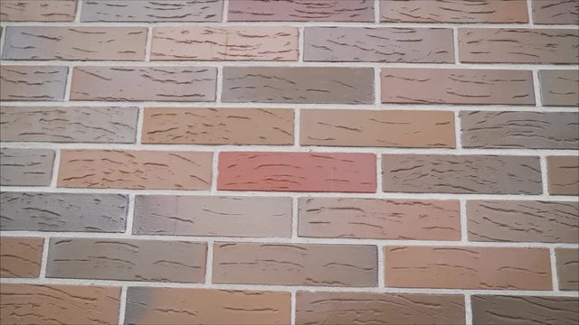 Tilting video footage from the windows and frontage on the facade. Facade of a colored brick house