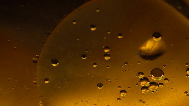 Psychedelic blue and yellow oil and water abstract background. Abstract colorful 4K video. Foam of Soap with Bubbles macro shot.Closeup bubbles in water. Oil drops on a water surface blue and yellow