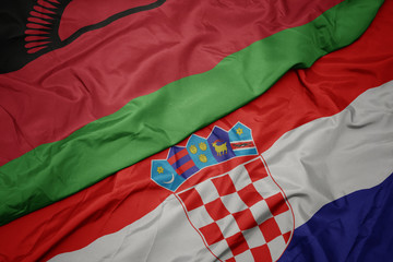 waving colorful flag of croatia and national flag of malawi.