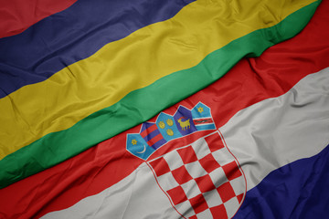 waving colorful flag of croatia and national flag of mauritius