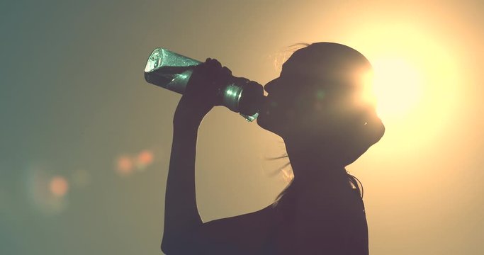 Female drinking bottle of water. 
