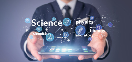 Businessman holding Science icons and title