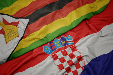 waving colorful flag of croatia and national flag of zimbabwe.