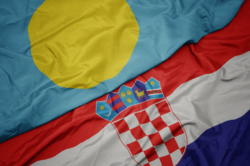 waving colorful flag of croatia and national flag of Palau .