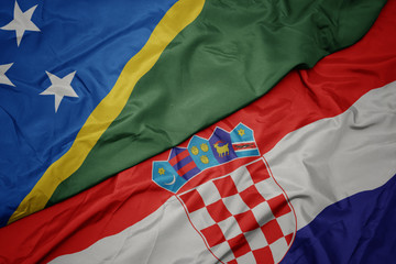 waving colorful flag of croatia and national flag of Solomon Islands .