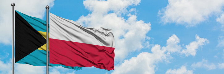 Bahamas and Poland flag waving in the wind against white cloudy blue sky together. Diplomacy concept, international relations.