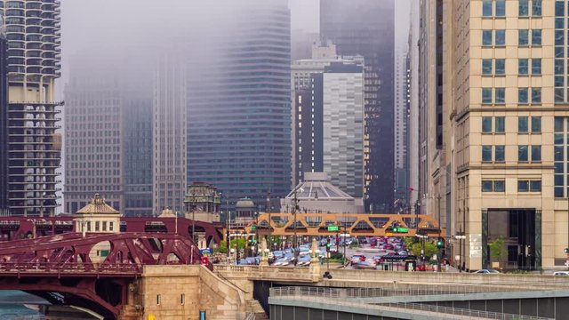 A busy main street in downtown on a foggy day. A time lapse of traffic on Wacker Drive in Chicago, Illinois.